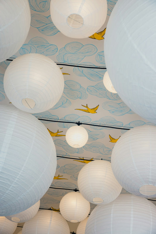 white paper lantern on black and white floral wall